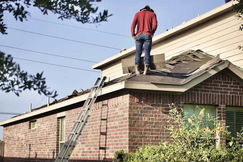 Professional roofer working on a residential roof in Spring Grove